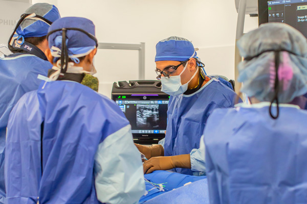 heart and vascular surgeon doctor saadat performs heart surgery with a surgical team