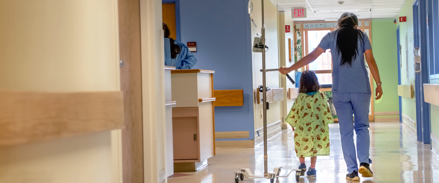 pediatric patient and baystate children’s hospital staff walking together down hospital hallway