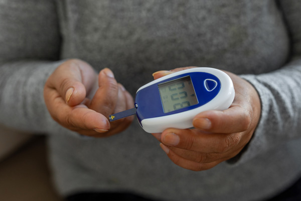 a person checking their blood sugar with a glucose monitor