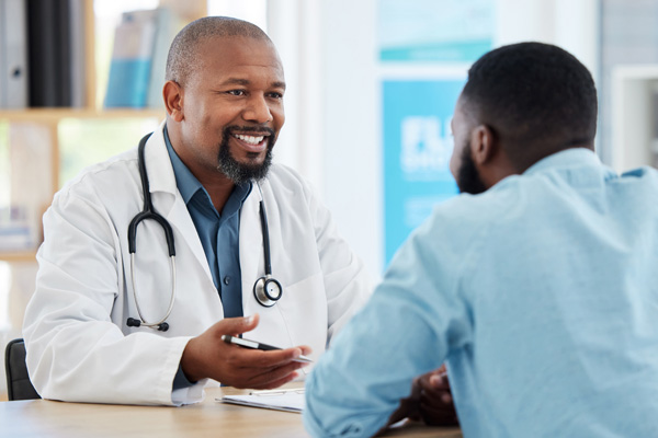 a Black man consulting his doctor about sickle cell disease