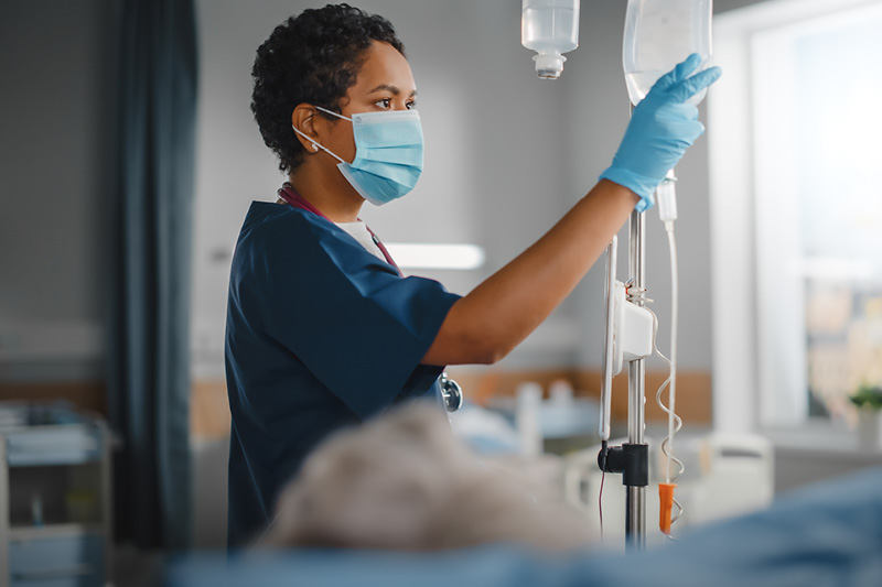 physician checking the levels on an IV bag