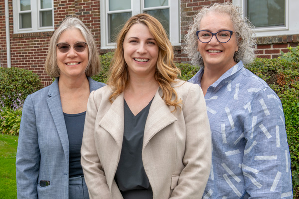 Heather Sanky, Burkman Endowed Chair of Obstetrics & Gynecology, Division of Midwifery Director Autumn Versace, and Former Director of Midwifery Susan DeJoy outside the Midwifery House in Springfield.