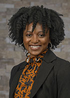 Formal portrait of a smiling Dr Kassandra Jean-Marie