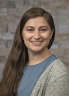 Smiling formal portrait of Dr Alexis Watson