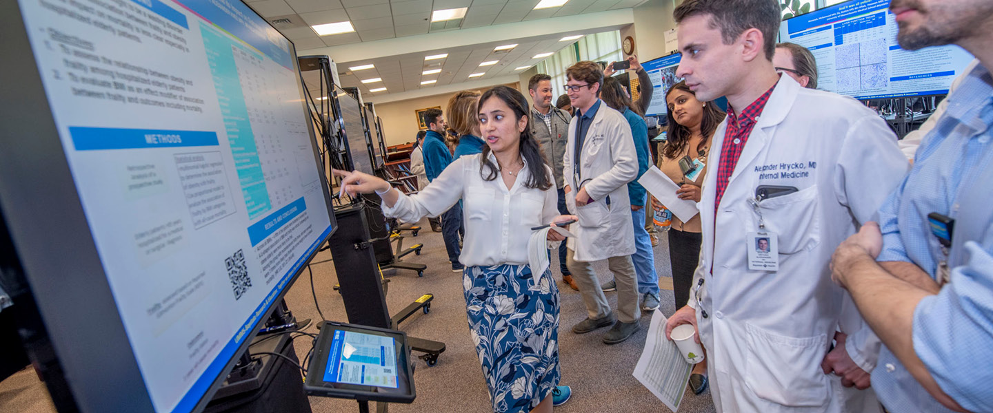 researchers looking at a touchscreen presentation