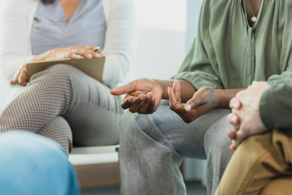 an adult woman shares her story at a bariatric surgery support group session