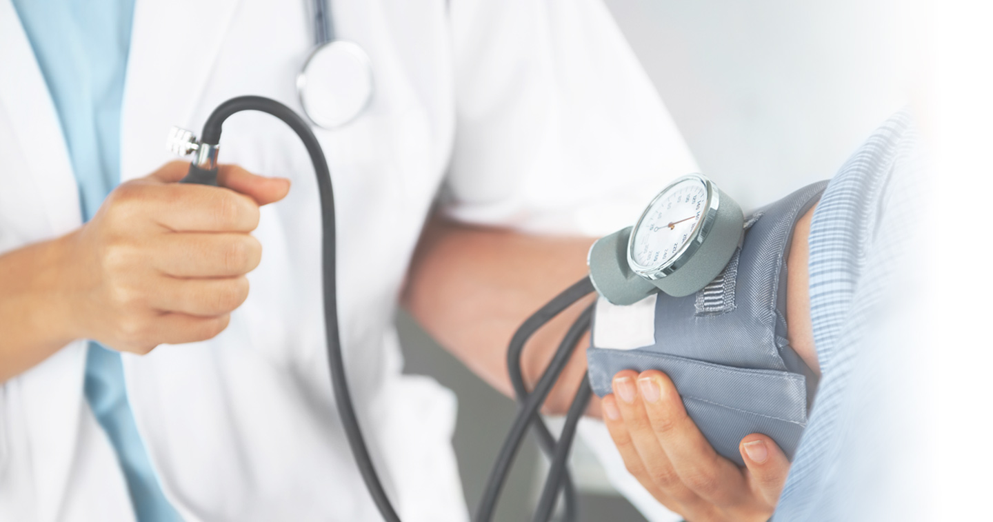 doctor taking patient's blood pressure with blood pressure cuff