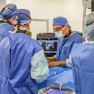 heart and vascular surgeon doctor saadat performs heart surgery with a surgical team